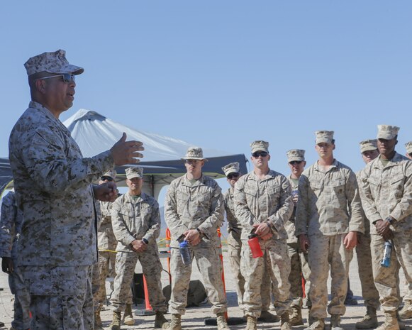 U.S. Marine Corps Col. Rey Masinsin, director of the Joint Non-Lethal Weapons Directorate briefs Marines with 2nd Low Altitude Air Defense Battalion, Marine Air Control Group 28, 2nd Marine Air Wing on the Active Denial System during Weapons and Tactics Instructor course (WTI) 2-17 at Site 50, Wellton, Ariz., April 4, 2017. The Aviation Development, Tactics and Evaluation Department and Marine Operational Test and Evaluation Squadron One (VMX-1) Science and Technology Departments conducted the tactical demonstration to explore and expand existing capabilities. MAWTS-1 provides standardized advanced tactical training and certification of unit instructor qualifications to support Marine Aviation Training and Readiness and assist in developing and employing aviation weapons and tactics. (U.S. Marine Corps photo by Lance Cpl. Andrew M. Huff)