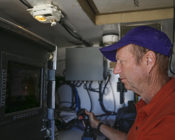 Mr. Paul Pelletier, senior engineer at the Joint Non-Lethal Weapons Directorate controls the Active Denial System (ADS) during Weapons and Tactics Instructor course (WTI) 2-17 at Site 50, Wellton, Ariz., April 4, 2017. The Aviation Development, Tactics and Evaluation Department and Marine Operational Test and Evaluation Squadron One (VMX-1) Science and Technology Departments conducted the tactical demonstration to explore and expand existing capabilities. MAWTS-1 provides standardized advanced tactical training and certification of unit instructor qualifications to support Marine Aviation Training and Readiness and assist in developing and employing aviation weapons and tactics. (U.S. Marine Corps photo by Lance Cpl. Andrew M. Huff)