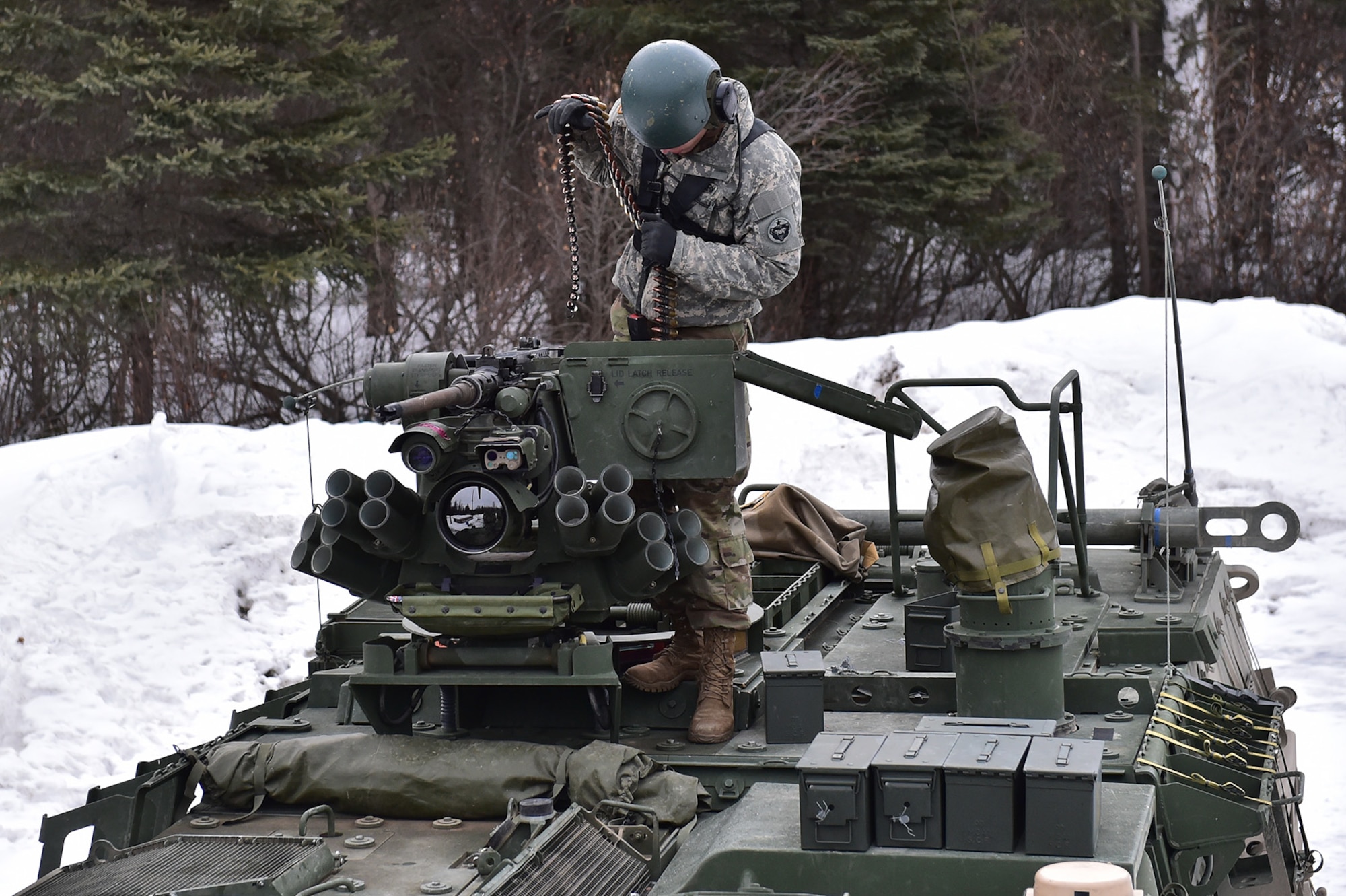 A soldier assigned to the 95th Chemical Company, “Arctic Dragons”, 17th Combat Sustainment Support Battalion, U.S. Army Alaska, loads .50 caliber machine gun ammunition at a supply point before a gunnery live-fire exercise with M1135 Stryker Nuclear Biological Chemical Reconnaissance Vehicles on Joint Base Elmendorf-Richardson, Alaska, April 5, 2017.  The gunnery tested Soldier’s proficiency with identifying, engaging, and eliminating hostile targets while increasing combat effectiveness. The Styker NBCRV provides Nuclear, Biological, and Chemical detection and surveillance for battlefield visualization, and situational awareness to increase unit combat power.  The core of the NBCRV is its on-board integrated NBC sensor suite, and integrated meteorological system.  An NBC positive overpressure system minimizes cross-contamination of samples and detection instruments, provides crew protection, and allows extended operation at Mission Oriented Protective Posture. 