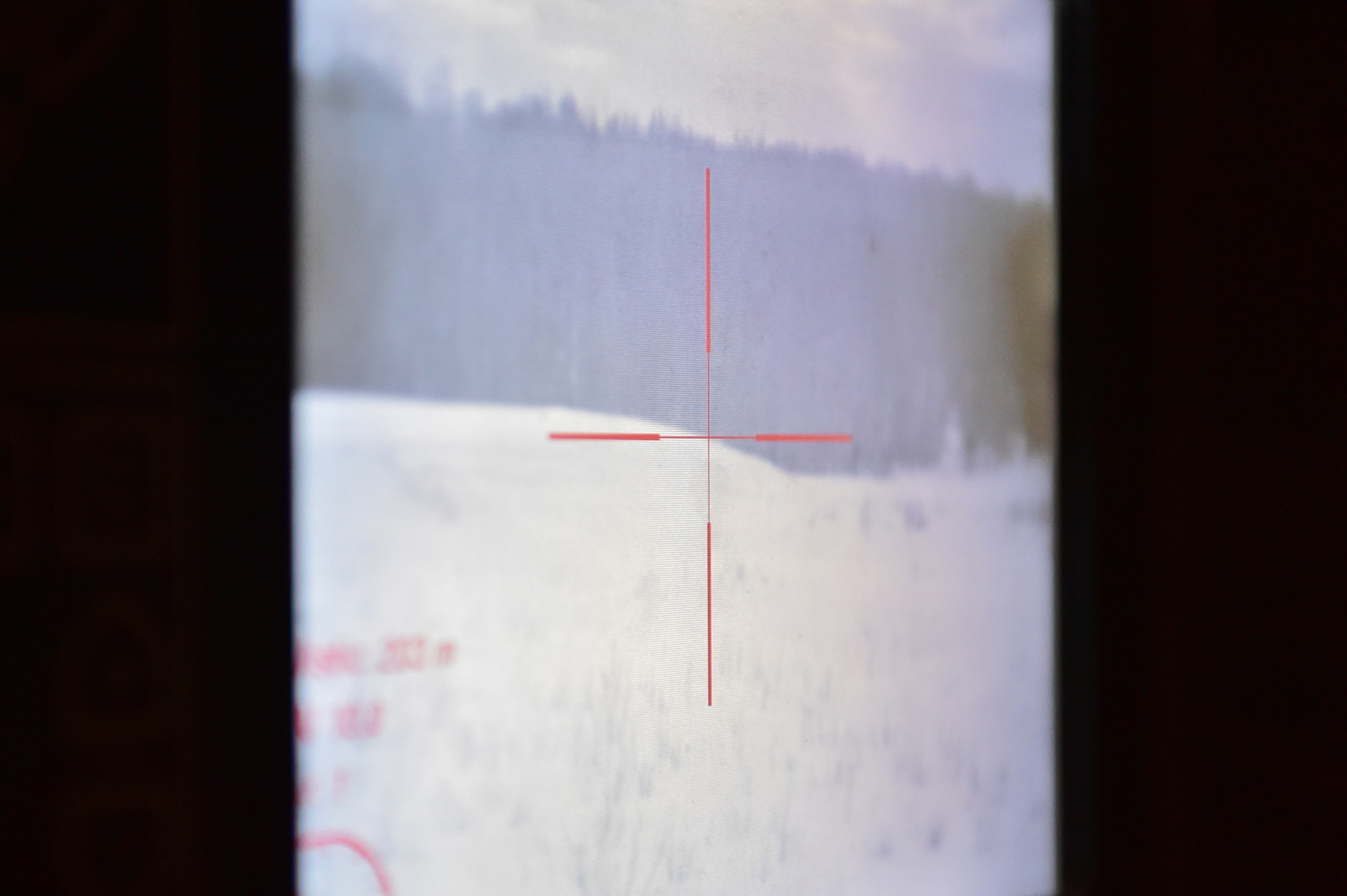 The aiming reticle is seen on a screen as Army Sgt. Mayra Haynes, a native of Anaheim, Calif., assigned to the 95th Chemical Company, “Arctic Dragons”, 17th Combat Sustainment Support Battalion, U.S. Army Alaska, scans for targets during a gunnery live-fire exercise with M1135 Stryker Nuclear Biological Chemical Reconnaissance Vehicles on Joint Base Elmendorf-Richardson, Alaska, April 5, 2017.  The gunnery tested Soldier’s proficiency with identifying, engaging, and eliminating hostile targets while increasing combat effectiveness. The Styker NBCRV provides Nuclear, Biological, and Chemical detection and surveillance for battlefield visualization, and situational awareness to increase unit combat power.  The core of the NBCRV is its on-board integrated NBC sensor suite, and integrated meteorological system.  An NBC positive overpressure system minimizes cross-contamination of samples and detection instruments, provides crew protection, and allows extended operation at Mission Oriented Protective Posture.