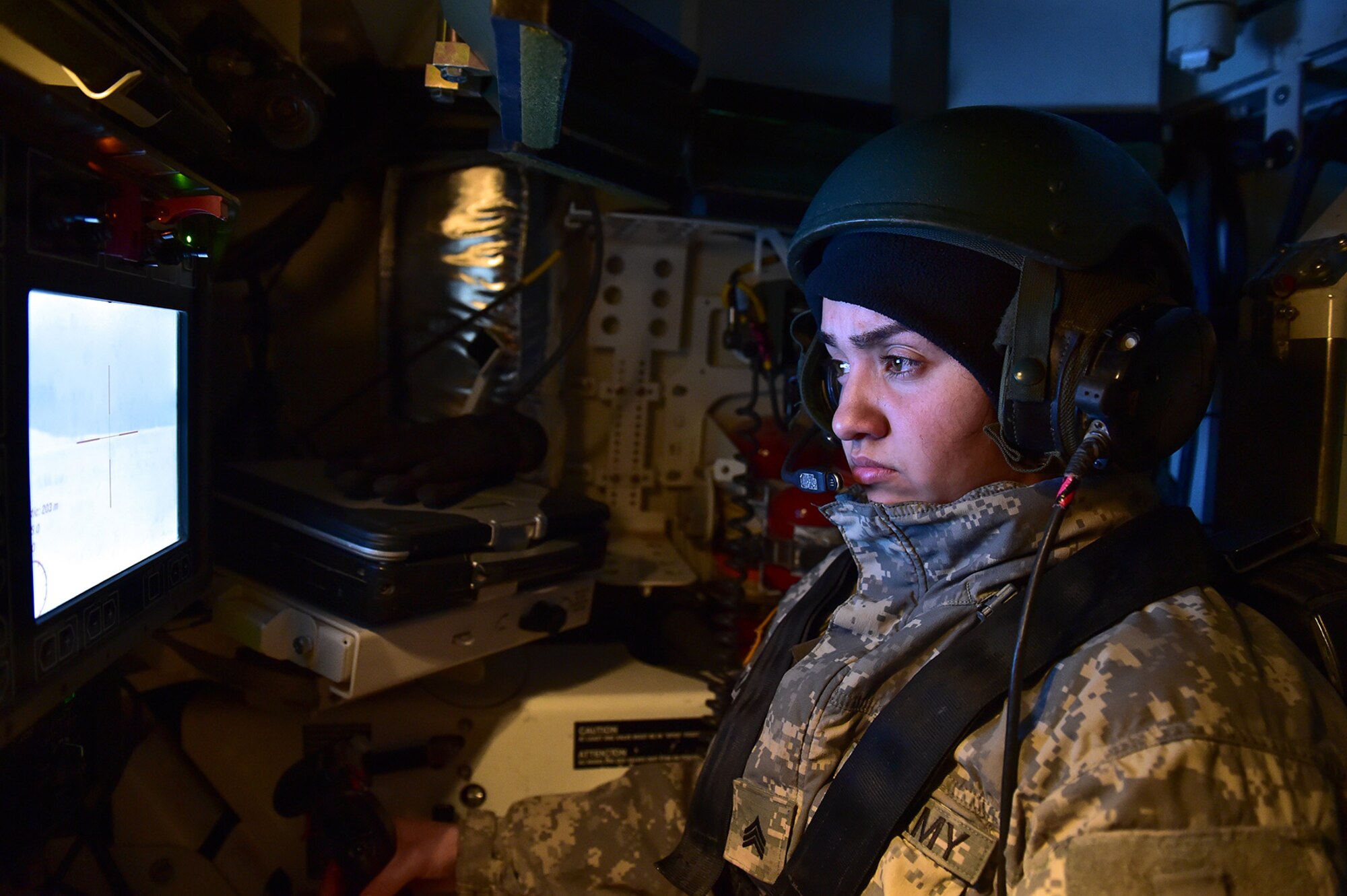 The aiming reticle is seen on a screen in front of Army Sgt. Mayra Haynes, a native of Anaheim, Calif., assigned to the 95th Chemical Company, “Arctic Dragons”, 17th Combat Sustainment Support Battalion, U.S. Army Alaska, as she scans for targets during a gunnery live-fire exercise with M1135 Stryker Nuclear Biological Chemical Reconnaissance Vehicles on Joint Base Elmendorf-Richardson, Alaska, April 5, 2017.  The gunnery tested Soldier’s proficiency with identifying, engaging, and eliminating hostile targets while increasing combat effectiveness. The Styker NBCRV provides Nuclear, Biological, and Chemical detection and surveillance for battlefield visualization, and situational awareness to increase unit combat power.  The core of the NBCRV is its on-board integrated NBC sensor suite, and integrated meteorological system.  An NBC positive overpressure system minimizes cross-contamination of samples and detection instruments, provides crew protection, and allows extended operation at Mission Oriented Protective Posture.