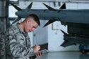 U.S. Air Force Airman 1st Class James Armeni, 20th Aircraft Maintenance 
Squadron weapons load crew member, documents munitions loaded onto an F-16CM Fighting Falcon at Shaw Air Force Base, S.C., April 3, 2017. During the load crew competition, the two teams loaded a GBU-12 Paveway II laser-guided bomb, AIM-120 advanced medium-range air-to-air missile, and AIM-9X Sidewinder missile onto F-16s. (U.S. Air Force photo by Airman 1st Class Kathryn R.C. Reaves)