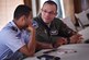 U.S. Air Force Capt. Ricardo Sequeira, 628th Medical Operations Support Squadron and 14th Airlift Squadron flight surgeon, Joint Base Charleston, South Carolina, right, talks to a member of the Honduran air force about flight medicine during an aerospace medicine subject matter expert exchange in Tegucigalpa, Honduras, April 4. The goal of the global health exchange is to share best practices, enhance relationships, and build partnership capacities.