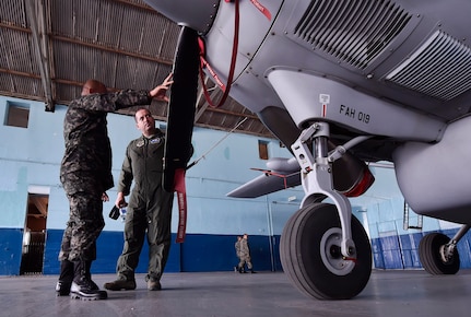 U.S. Air Force Capt. Diego Torres, Detachment 4, 375th Operations Group flight nurse instructor and evaluator, Wright-Patterson Air Force Base, Ohio, right, tours a Honduran air force hangar with Honduran Air Force Jefe Primero Juan Carlos Rodriguez, Fuerza Aérea Honduras chief of maintenance, during an aerospace medicine subject matter expert exchange in Tegucigalpa, Honduras, April 4. The goal of the global health exchange is to share best practices, enhance relationships, and build partnership capacities. 