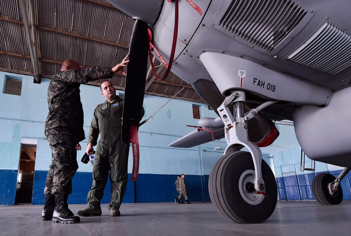 U.S. Air Force Capt. Diego Torres, Detachment 4, 375th Operations Group flight nurse instructor and evaluator, Wright-Patterson Air Force Base, Ohio, right, tours a Honduran air force hangar with Honduran Air Force Jefe Primero Juan Carlos Rodriguez, Fuerza Aérea Honduras chief of maintenance, during an aerospace medicine subject matter expert exchange in Tegucigalpa, Honduras, April 4. The goal of the global health exchange is to share best practices, enhance relationships, and build partnership capacities. 