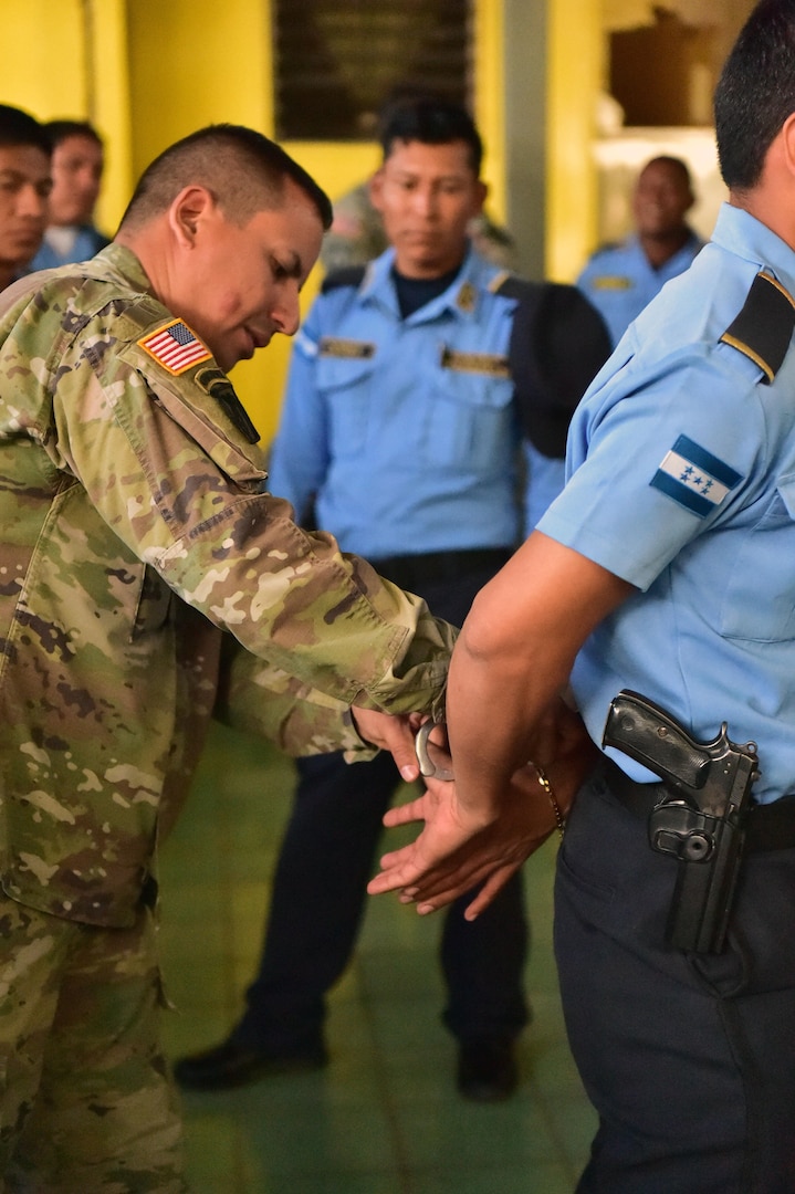 Staff Sgt. José Alequin, Joint Task Force-Bravo Joint Security Forces, shows participants how to properly immobilize a person during a Subject Matter Expert Exchange between JSF and local public forces in Comayagua.