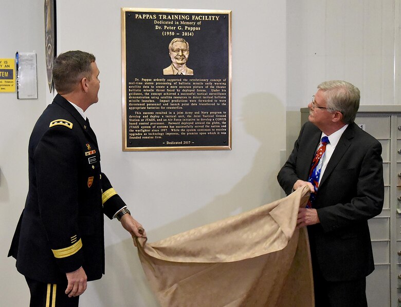 COLORADO SPRINGS, Colo. - Lt. Gen. James Dickinson, commanding general, U.S. Army Space and Missile Defense Command/Army Forces Strategic Command, and Larry Burger, former director of the Future Warfare Center, unveil a memorial plaque during the Joint Tactical Ground Station Dr. Peter G. Pappas Training Facility dedication in Colorado Springs, Colorado, April 6. (Photo Credit: Ms. Dottie K. White (USASMDCARSTRAT))