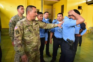Staff Sgt. José Alequin, Joint Task Force-Bravo Joint Security Forces, shows participants how to properly immobilize a person during a Subject Matter Expert Exchange between JSF and local public forces in Comayagua.