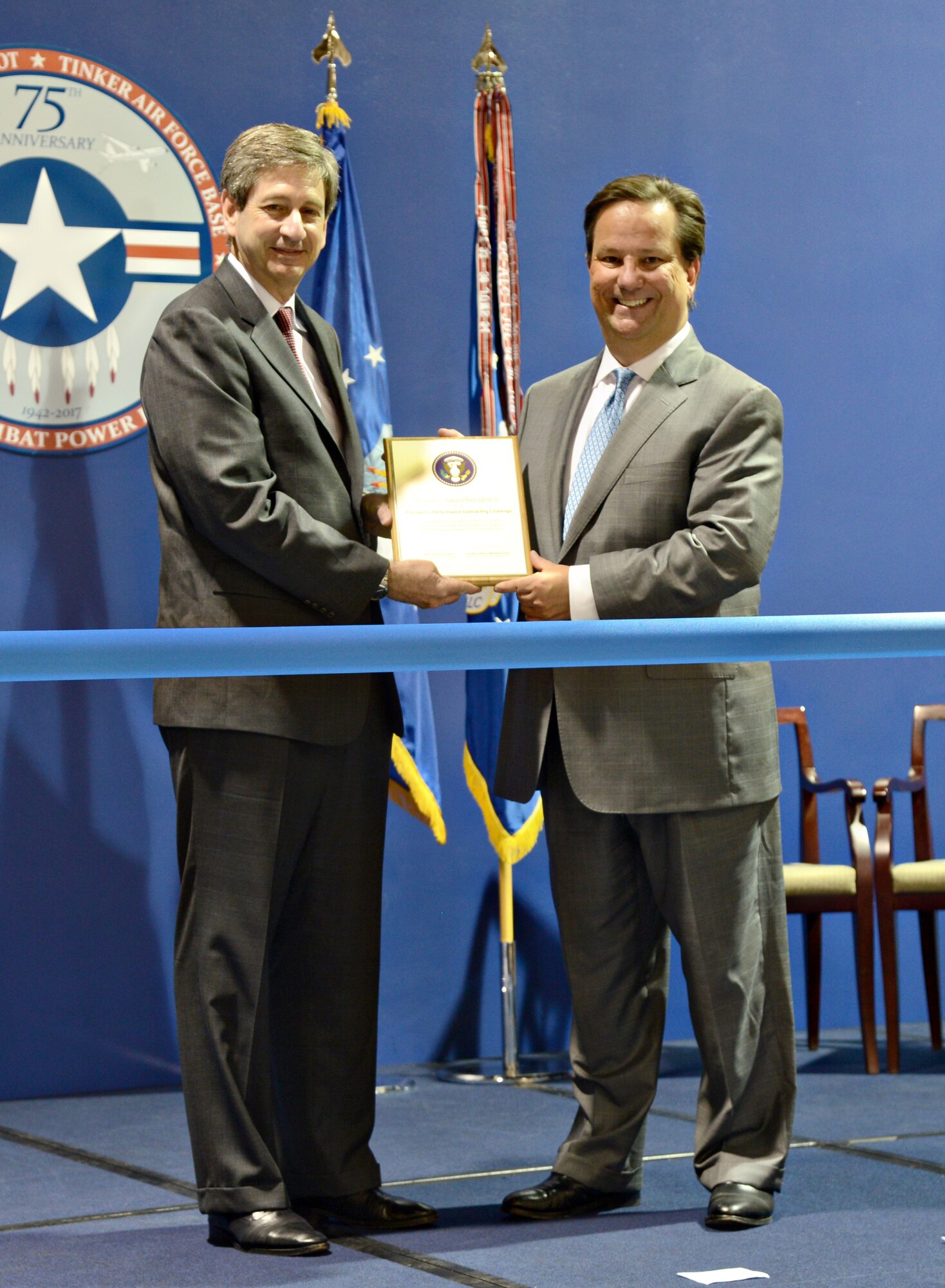 Mark Correll, deputy assistant secretary of the Air Force for Environment, Safety and Infrastructure, presents Wade Wolfe, vice director for the Oklahoma City Air Logistics Complex, with a Directors’ Award Recognition for the President’s Performance Contracting Challenge award for the OC-ALC’s efforts to achieve or exceed its target toward the President’s 2016 goal of $4 billion in energy and water efficiency investments. In 2011 and 2014, President Barack Obama challenged federal agencies to facilitate a total of $4 billion in energy efficiency upgrades to federal buildings with energy efficient performance contracts through 2016. As of December 2016, the agencies exceeded that goal, resulting in “21 federal agencies awarding 340 projects with over $4.2 billion in value,” according to a White House announcement. (Courtesy photo)