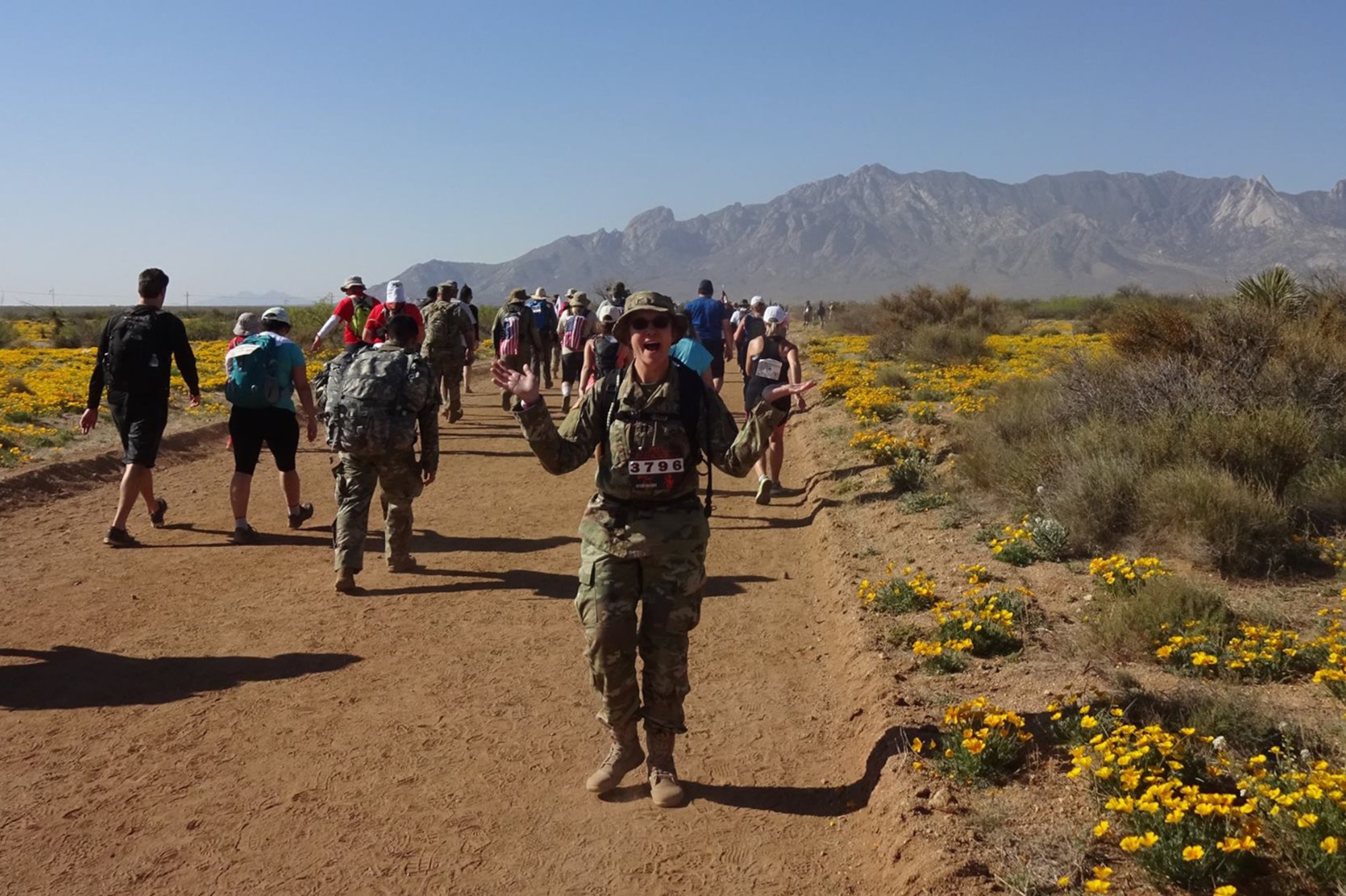 WHITE SANDS MISSILE RANGE, N.M. - Capt. Lacey Dean, U.S. Army Space and Missile Defense Command/Army Forces Strategic Command, shows her enthusiasm at mile seven of the 28th Bataan Memorial Death March at White Sands Missile Range, N.M., March 19. (Courtesy Photo)