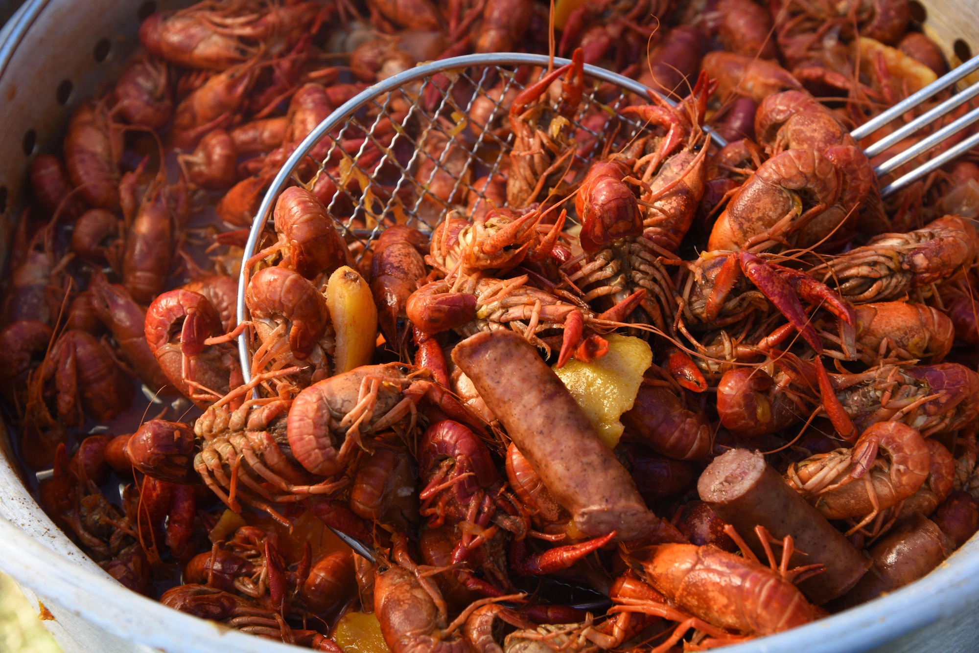 A pot of boiled crawfish and the ‘fixins’ soak in seasonings during the 5th Annual Bay Breeze Crawfish Cook-Off at the Bay Breeze Event Center April 7, 2017, on Keesler Air Force Base, Miss. The “Keesler Chiefs” won first place overall and a free entry into the 25th Annual Mississippi Coast Coliseum Crawfish Festival Cook-Off. (U.S. Air Force photo by Kemberly Groue)