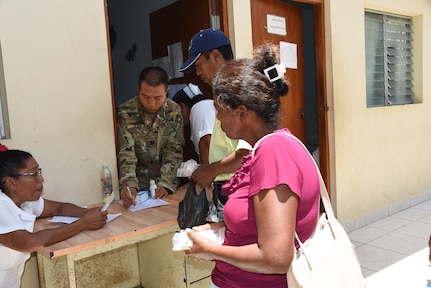 Capt. Ken Lau, Joint Task Force-Bravo’s Medical Element Pharmacy Technician, hands out medicine to Nicaraguans of the local village of Waspam during a three day Medical Readiness Exercise March 28-31. More than 1,600 patients were seen over the few days. 