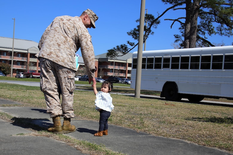 MARINE CORPS AIR STATION CHERRY POINT, N.C.—Cpl. Joseph Capellini walks with his daughter while his family waits to bid him farewell for a deployment from Marine Corps Air Station Cherry Point, N.C., March 29, 2017. The mission of Marine Tactical Electronic Warfare Squadron 3, Marine Aircraft Group 14, 2nd Marine Aircraft Wing, during the deployment will be to conduct airborne electronic warfare in support of operations. This includes the EA-6B Prowler’s unique ability to suppress enemy radar and surface-to-air missiles utilizing electronic jamming and high-speed anti-radiation missiles, as well as collect tactical intelligence in a passive electronic support role. Capellini is a hydraulic mechanic with Marine Aviation Logistics Squadron 14, MAG-14, 2nd MAW. (U.S. Marine Corps photo by Cpl. Mackenzie Gibson/ Released)