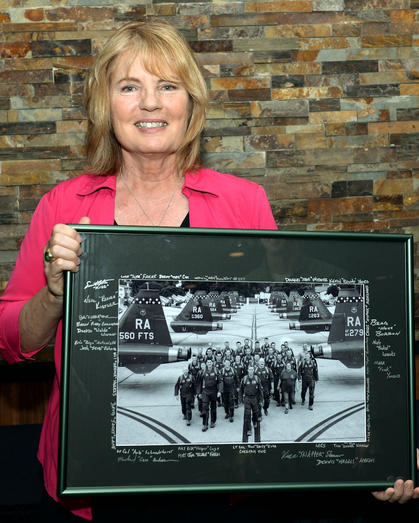 Christina Olds, daughter of retired Brig. Gen. Robin Olds, holds a photograph presented to her by the 560th Flying Training Squadron at the Auger Inn on Joint Base San Antonio-Randolph, Texas, March 30, 2017. Olds shared stories of her father’s distinguished Air Force career as a triple ace. (U.S. Air Force photo by Staff Sgt. Michelle Patten)