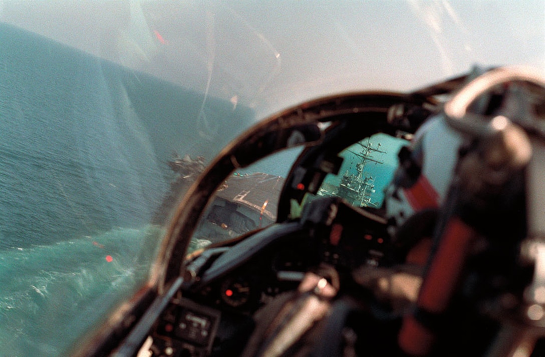 As seen from back seat of Fighter Squadron 41 F-14A Tomcat aircraft, pilot brings aircraft in for arrested landing on flight deck of USS Theodore Roosevelt during Operation Desert Storm (DOD/Parsons)