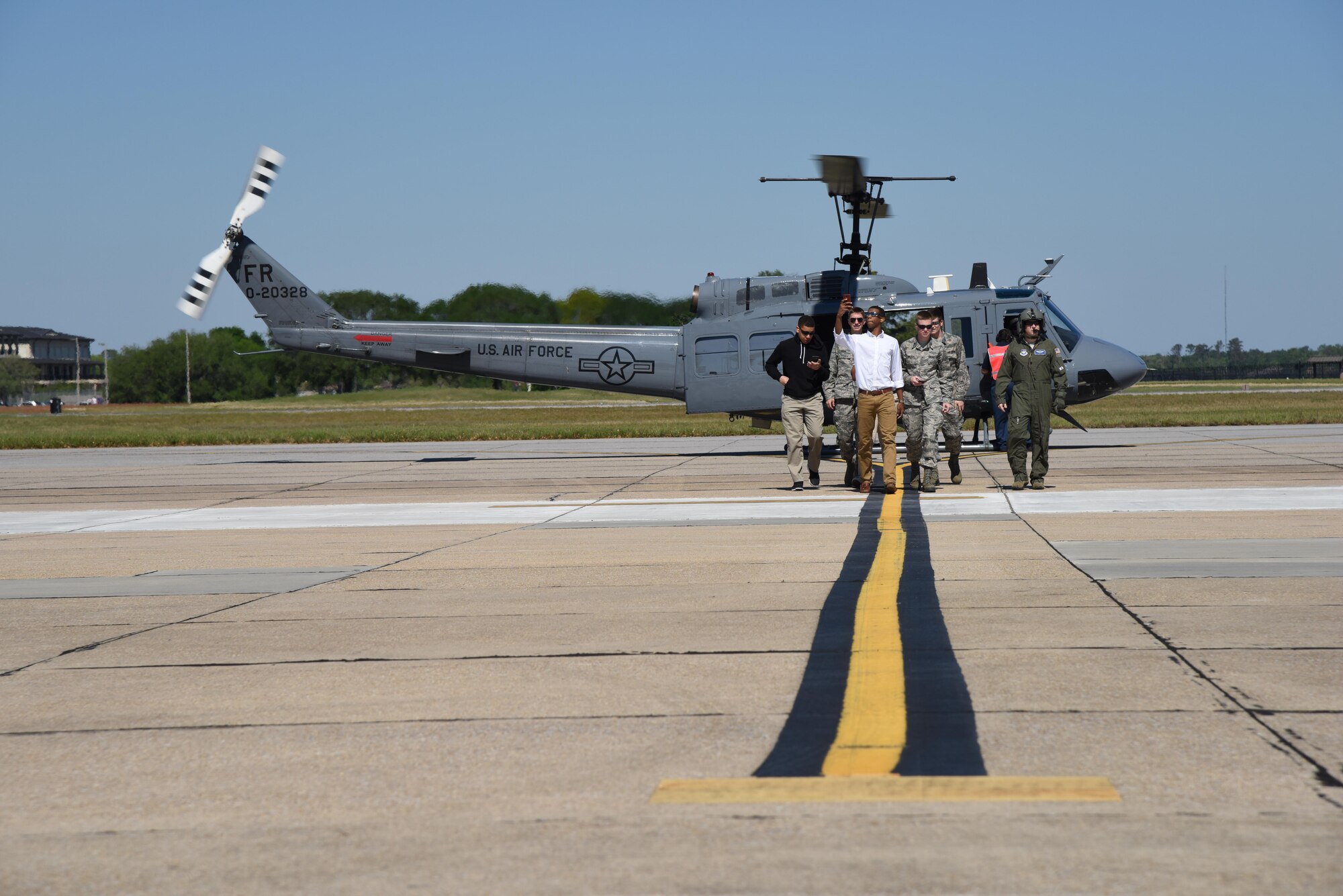 Air Force ROTC cadets offload from a TH-1H Huey after an incentive ride during Pathways to Blue April 8, 2017, on Keesler Air Force Base, Miss. Pathways to Blue, an annauloutreach event hosted by 2nd Air Force with the support of the 81st Training Wing and the 403rd Wing, allowing cadets to receive hands-on briefings with technical and flying operations and an orientation flight in support of the Air Force's Diversity Strategic Roadmap program. (U.S. Air Force photo by Kemberly Groue)