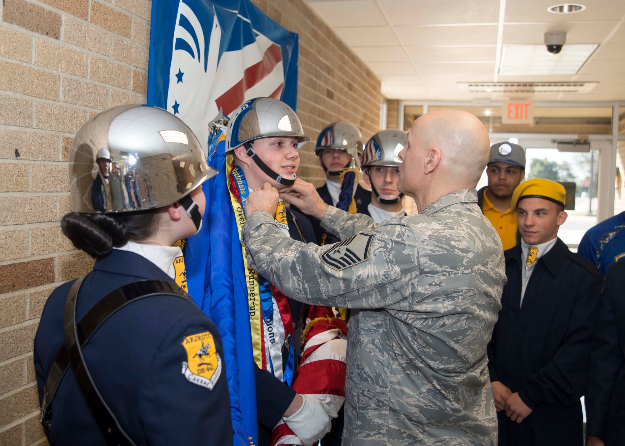 Master Sgt. Jon Wedel, Enlisted Air Force Junior Reserve Officer Training Corps Caesar Rodney instructor, fixes Cadet Taylor Mathews’ ascot prior to the colors demonstration during the 2017 Delaware State JROTC Drill Competition April 8, 2017, on Dover Air Force Base, Del. Cadets from Caesar Rodney JROTC color guard were given the honor to present the colors at the morning ceremony. (U.S. Air Force photo by Staff Sgt. Jared Duhon)