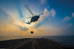 MH-60R Sea Hawk helicopter assigned to Vipers of Helicopter Maritime Strike Squadron 48 conducts vertical replenishment training aboard guided-missile cruiser USS Monterey, Gulf of Oman, November 21, 2016 (U.S. Navy/William Jenkins)