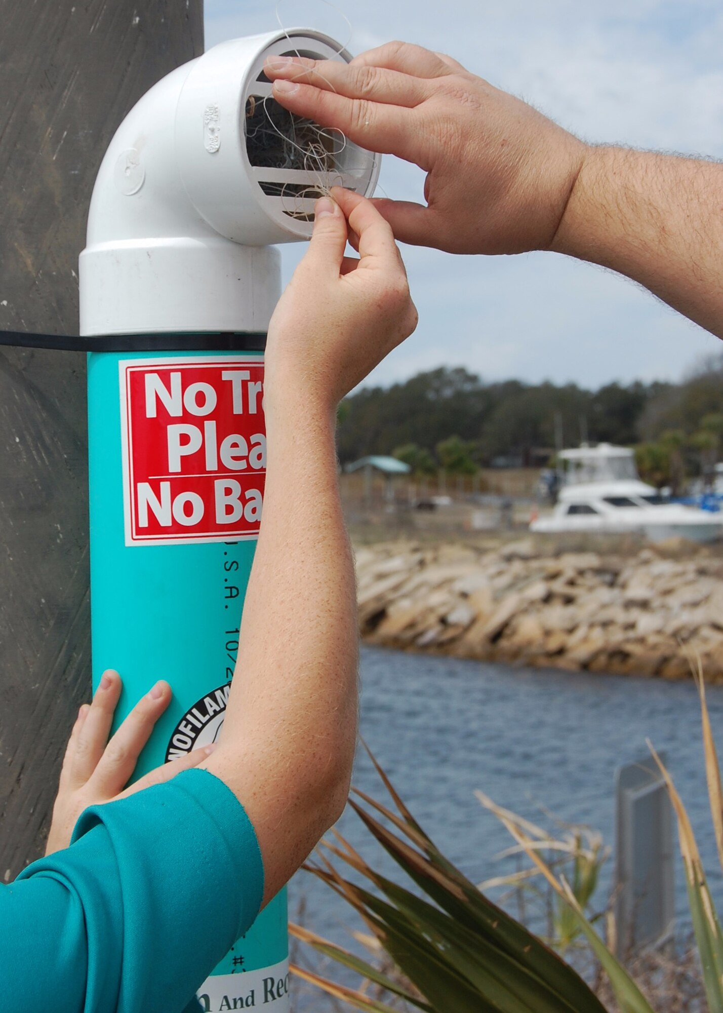 Visitor's dispose of fishing line at one of 15 recently installed recycling bins at Tyndall Air Force Base, Fla., March 25, 2017. The 325th Civil Engineer Squadron Natural Resources flight teamed up with Boy Scout Troop 302 of St. John’s Catholic Church to advance and sustain Tyndall’s natural resources and wildlife. (Courtesy photo)