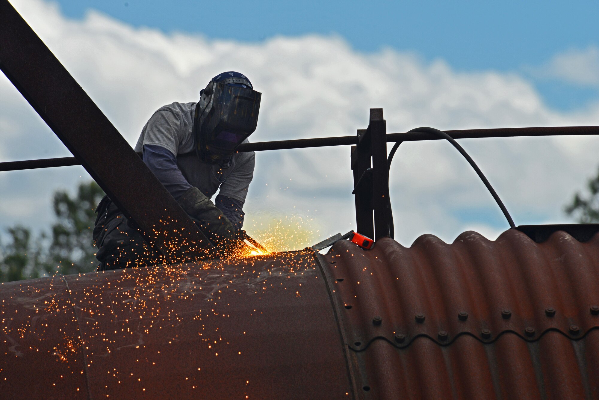 John Straka, contractor, repairs steel on top of an aircraft fire trainer at Shaw Air Force Base, S.C., April 6, 2017. The aircraft fire trainer allows 20th Civil Engineer Squadron firefighters to maintain their readiness to stop aircraft fires. (U.S. Air Force photo by Airman 1st Class Destinee Sweeney)
