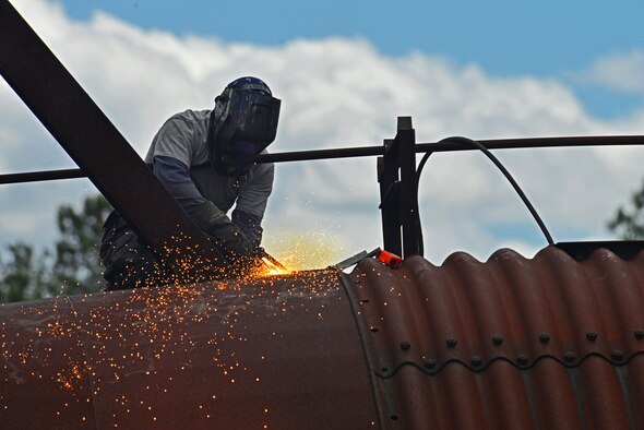 John Straka, contractor, repairs steel on top of an aircraft fire trainer at Shaw Air Force Base, S.C., April 6, 2017. The aircraft fire trainer allows 20th Civil Engineer Squadron firefighters to maintain their readiness to stop aircraft fires. (U.S. Air Force photo by Airman 1st Class Destinee Sweeney)