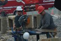 Ed Muller, left, and Chuck Pickard, right, contractors, cut a metal beam while repairing an aircraft fire trainer at Shaw Air Force Base, S.C., April 6, 2017. The contractors are renovating existing training structures on the 20th Civil Engineer Squadron fire emergency services training grounds, as well as adding an additional structure that will provide more opportunities for the firefighters to train skills such as roof ventilation. (U.S. Air Force photo by Airman 1st Class Destinee Sweeney)