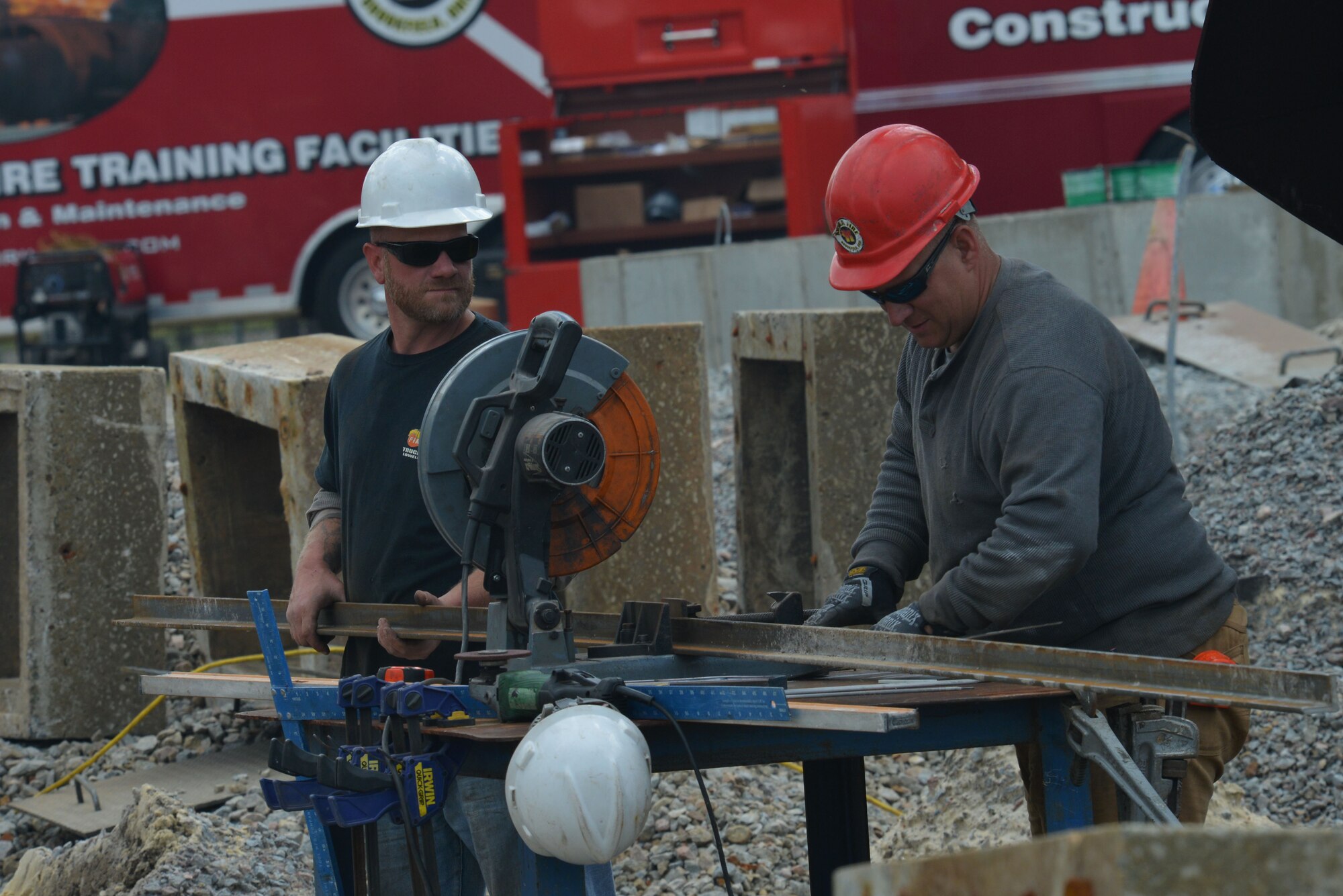 Ed Muller, left, and Chuck Pickard, right, contractors, cut a metal beam while repairing an aircraft fire trainer at Shaw Air Force Base, S.C., April 6, 2017. The contractors are renovating existing training structures on the 20th Civil Engineer Squadron fire emergency services training grounds, as well as adding an additional structure that will provide more opportunities for the firefighters to train skills such as roof ventilation. (U.S. Air Force photo by Airman 1st Class Destinee Sweeney)