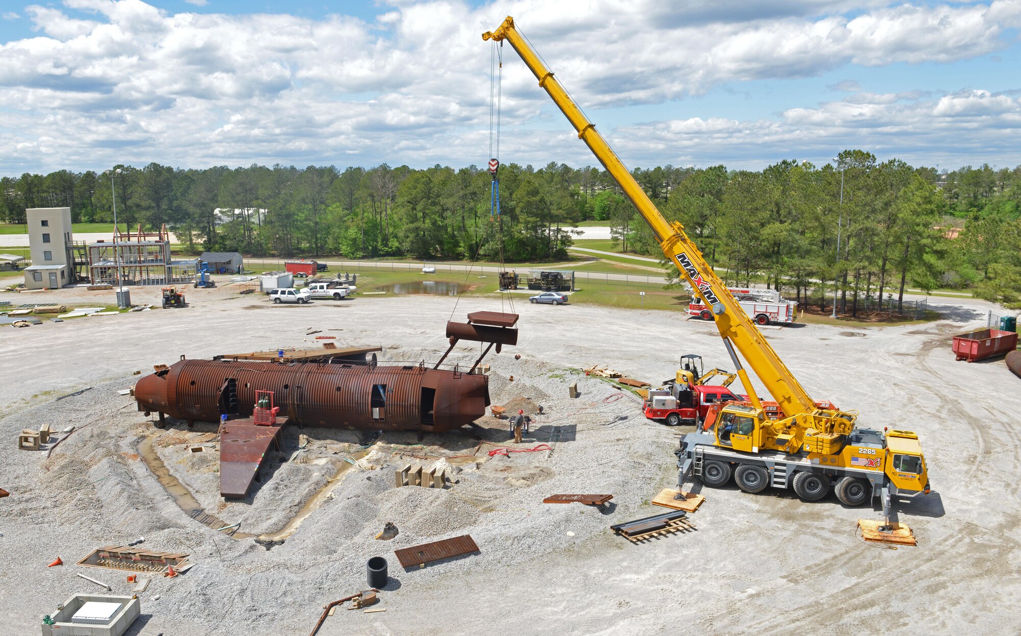 Contractors work on renovations to an aircraft fire trainer and a structure fire trainer at Shaw Air Force Base, S.C., April 6, 2017. The renovations include repairing the simulated aircraft and adding an additional building to the structure, which will give 20th Civil Engineer Squadron firefighters advanced training opportunities. (U.S. Air Force photo by Airman 1st Class Destinee Sweeney)
