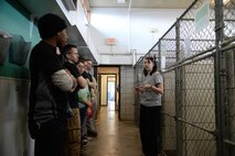 Alexis Topham, Souris Valley Animal shelter kennel assistant, speaks with 5th Logistics Readiness Squadron Airmen at the animal shelter in Minot, N.D., March 29, 2017.  The 5th LRS volunteers walked and played with the dogs during their visit to the shelter. (U.S. Air Force photo/Airman 1st Class Dillon J. Audit)