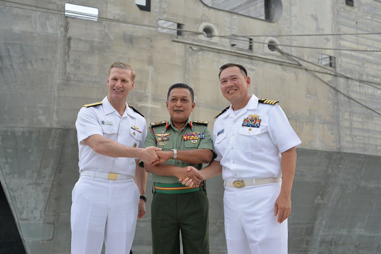 Vice Adm. Joseph P. Aucoin, left, commander of U.S. 7th Fleet; Lt. Gen. Dato' Fazil Bin Mukhtar, commander of Malaysia's Joint Forces Command; and Capt. Stansfield Chien, mission commander for Pacific Partnership 2017, pause for a photo in front of the expeditionary fast transport ship USNS Fall River (T-EPF 4) during the opening ceremony for the Malaysia phase of Pacific Partnership, April 10, 2017. The largest annual multilateral humanitarian assistance and disaster relief preparedness mission conducted in the Indo-Asia-Pacific, Pacific Partnership and aims to enhance regional coordination in areas such as medical readiness and preparedness for manmade and natural disasters. 