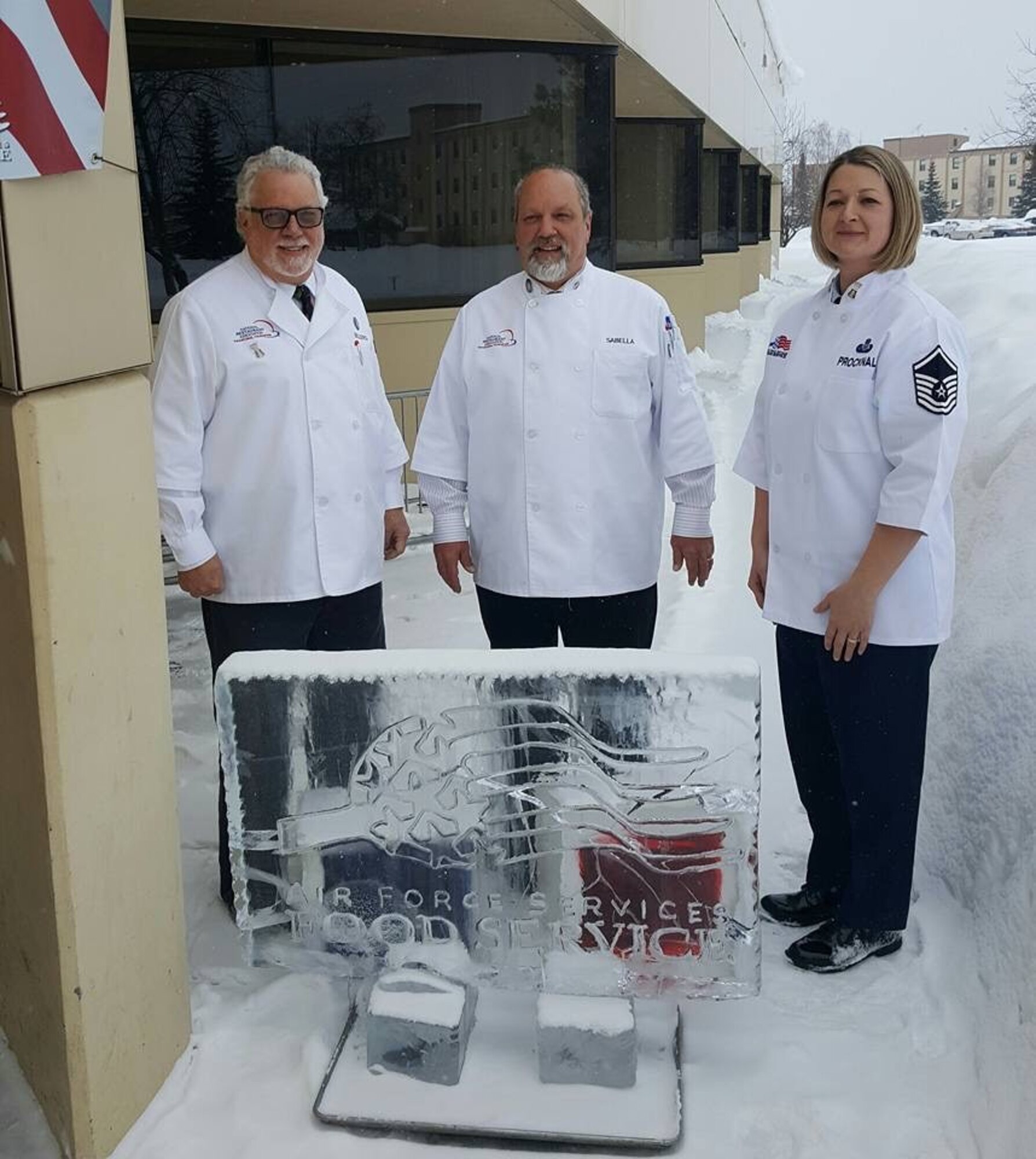 U.S. Air Force Master Sgt. Amanda Procknal leads fellow Hennessy Travelers Jim Sellers (left) and Mike Sabella to inspect food service operations at Eielson Air Force Base, Alaska.The food service staff created an ice sculpture to welcome them. (Courtesy photo)