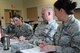 During an exercise demonstrating lean principles, from right, Master Sgt. Melissa Monson, Tech. Sgt. James Hubbard and Staff Sgt. Dianna Pena and Tech. Sgt. Shawna Damrow work as a team to prepare identical sets of index cards in as short a time as possible. The 8-Steps to Problem Solving class stresses process analysis as a way to identify waste and increase efficiency. (U.S. Air National Guard photo by Tech. Sgt. Jefferson Thompson)