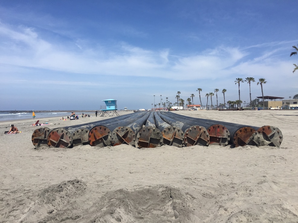 Manson Construction Company towed 11 sections of high-density polyethylene, or HDPE, pipe in preparation for the Oceanside Harbor dredging project. Manson will connect the 500-foot sections to place sand along the beach as the project works its way south.