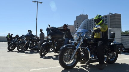 Joint Base San Antonio military members prepare to go out on a ride April 7 during the All Motorcycle Riders Call at Wilford Hall Ambulatory Surgical Center. Safety monitors demonstrated the correct hand signals and proper personal protective gear to use when riding. (U.S. Air Force photo/Staff Sgt. Kevin Iinuma)