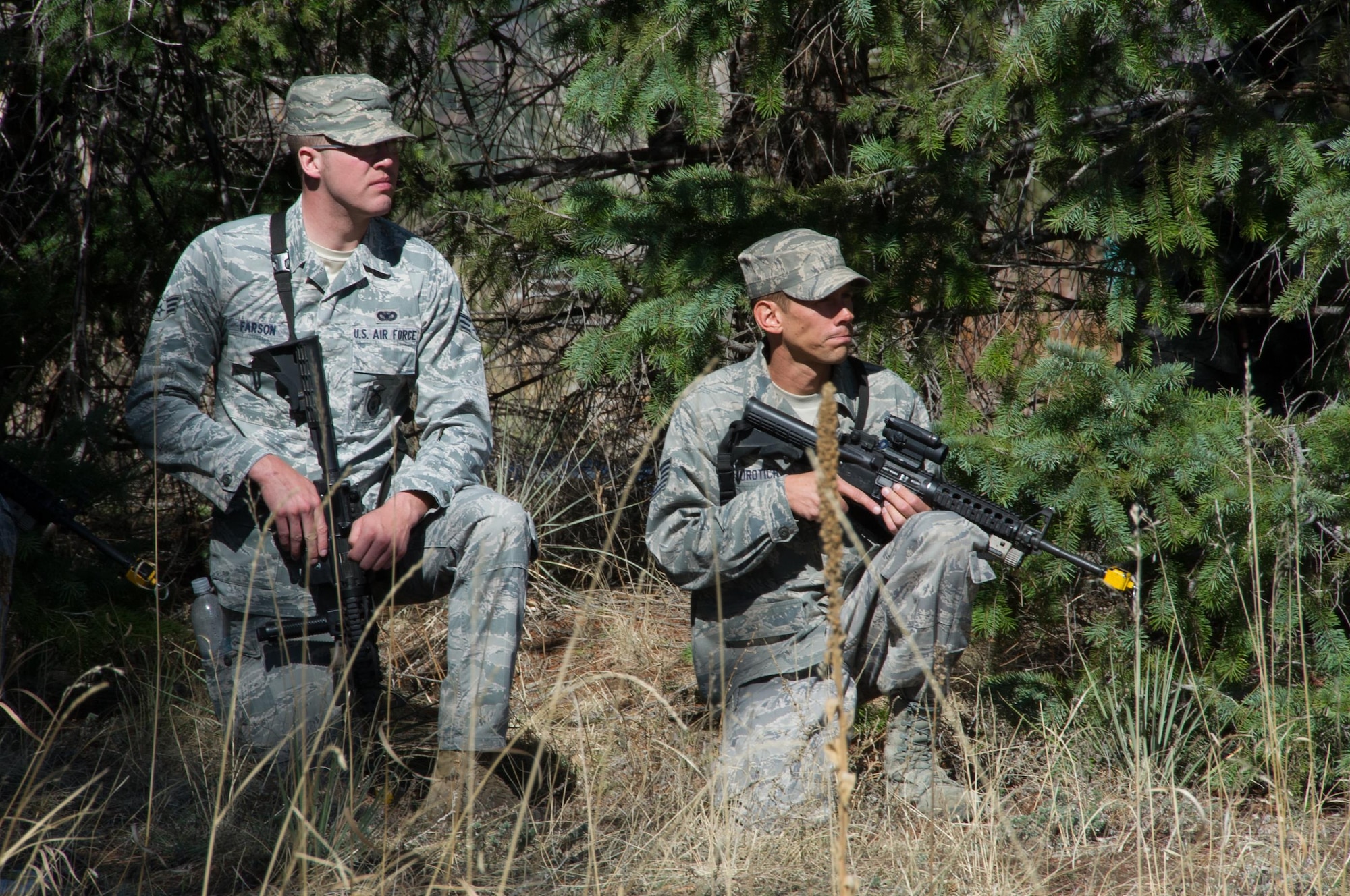 SCHREIVER AIR FORCE BASE, Colo. -- Senior Airman Tyler Farson, 10th Security Forces Squadron, and Tech. Sgt. Luke Jurotich, 710th SFS, keep watch over their position during the 2017 Reduced Combat Leaders Course, held at the U.S. Air Force Academy in Colorado, on Friday, Apr. 7th, 2017. The course provides seven days of classroom and field training exercises that focus on developing combat leadership skills of junior non-commissioned officers and company grade officers in the Security Forces career field. (U.S. Air Force photo/Senior Airman Laura Turner)