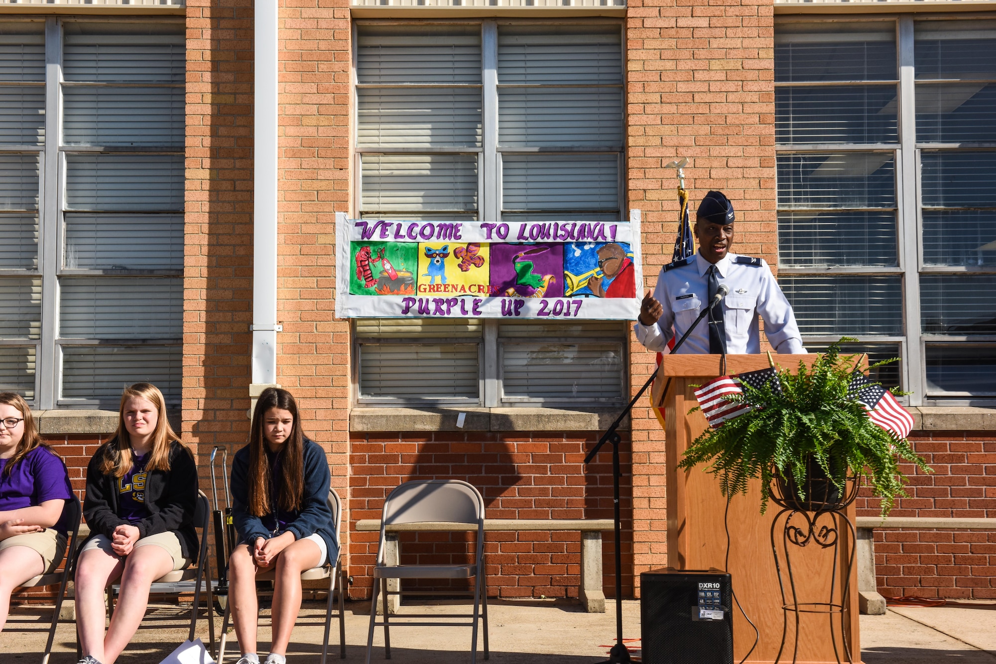 Col. Brandon Parker, 2nd Bomb Wing vice commander, comments on the responsibility, sacrifices, and service that military children provide during Purple-Up Day in Bossier City, La., April 7, 2017. Purple is used to represent all of the military branches and Purple-Up Day is an opportunity for civilians and military members to recognize the sacrifices children make alongside their military parents. (U.S. Air Force photo/Senior Airman Luke Hill)