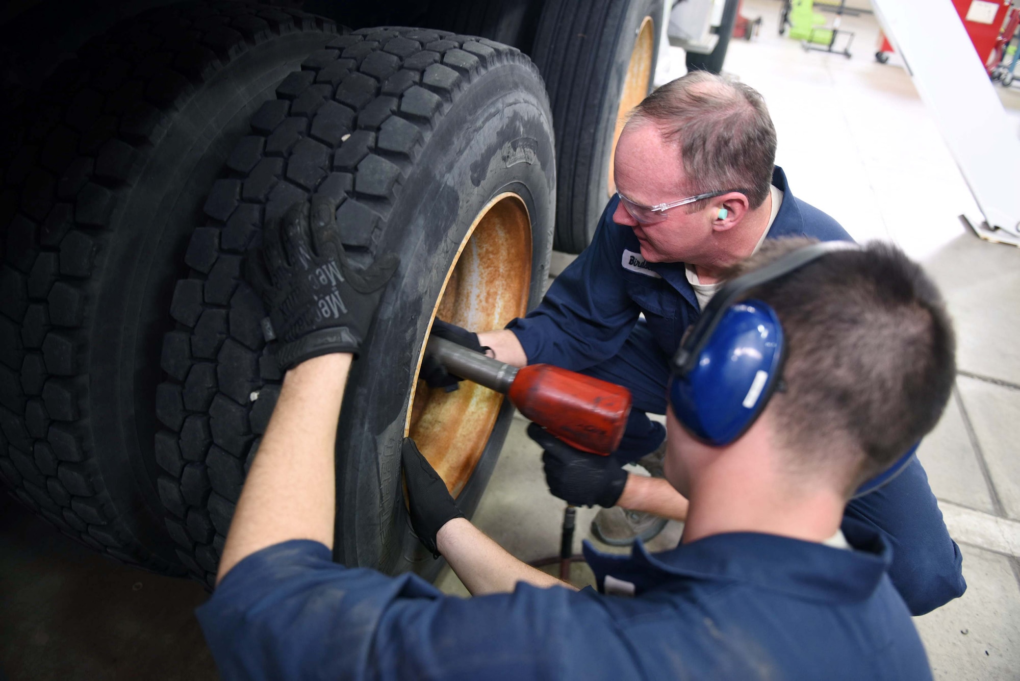 Col. Gregory Wood, 30th Space Wing vice commander, assists Senior Airman Christopher Champagne, 30th Logistics Readiness Squadron vehicle maintainer, remove the wheels of an Altec crane, April 7, 2017, at Vandenberg Air Force Base, Calif. Wood visited the 30th LRS to interact with Airmen and experience the mission.  (U.S. Air Force photo by Tech. Sgt. Jim Araos/Released)