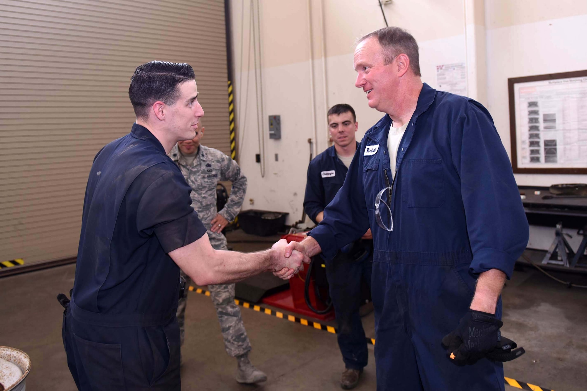 Col. Gregory Wood, 30th Space Wing vice commander, thanks Senior Airman Nathan Sine, 30th Logistics Readiness Squadron vehicle maintainer, April 7, 2017, at Vandenberg Air Force Base, Calif. Wood visited the 30th LRS to interact with Airmen and experience the mission.  (U.S. Air Force photo by Tech. Sgt. Jim Araos/Released)