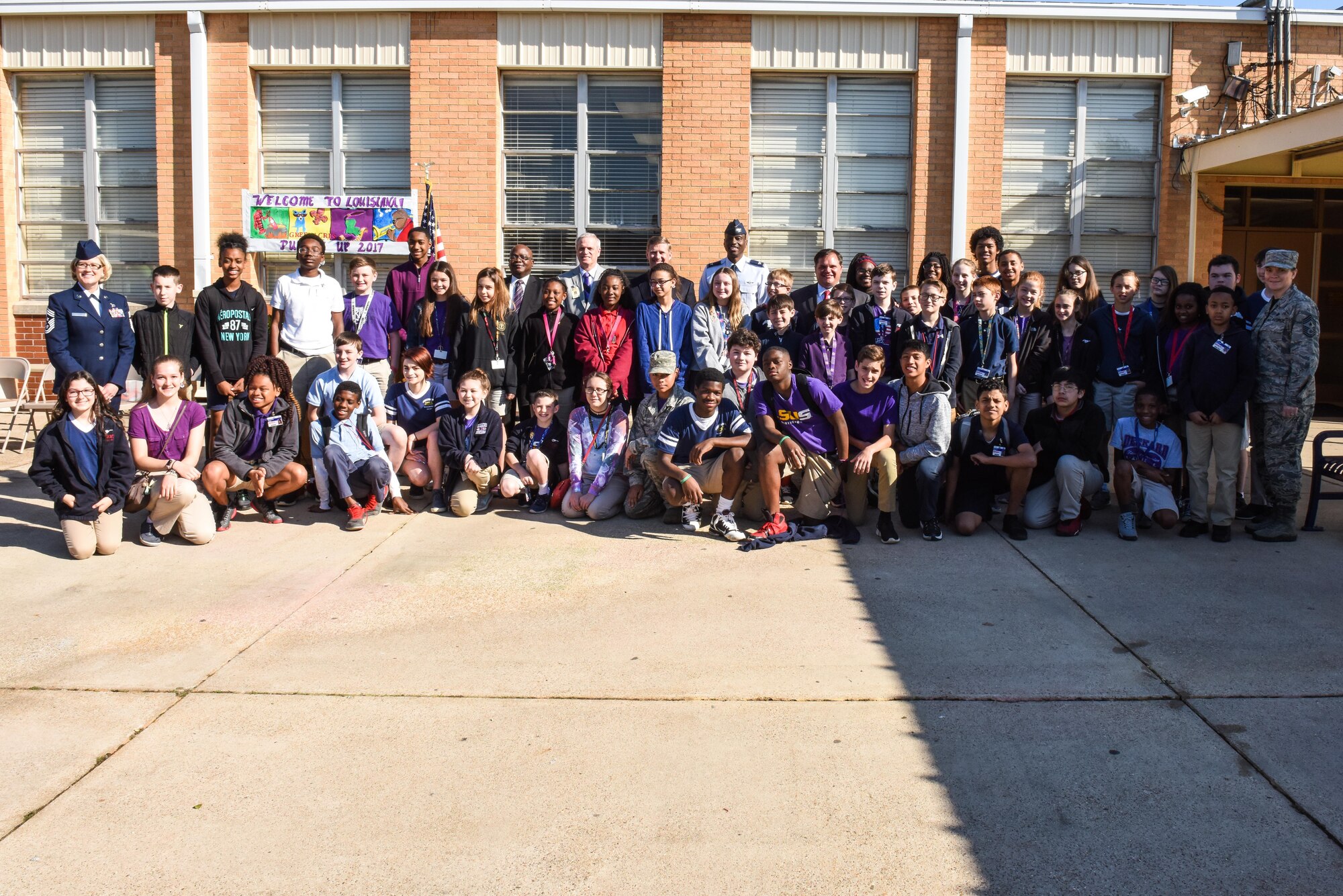 Senators, school superintendents, congressmen, base personnel and military children pose for a photo during Purple-Up Say in Bossier City, La., April 7, 2017. Purple-Up Day is a way for the community to showcase their appreciation and give back to the children who serve. This year included a military child parade and ice cream for the kids after the ceremony. (U.S. Air Force photo/Senior Airman Luke Hill)