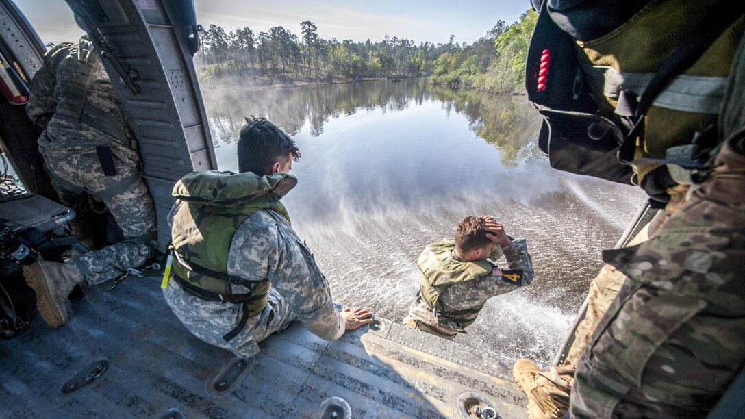 An Army Ranger jumps from a helicopter into Victory Pond during the final day of the 34th Annual David E. Grange Jr. Best Ranger Competition at Fort Benning, Ga., April 9, 2017. The three-day event tests competitors' physical, mental and technical capabilities. Army photo by Patrick A. Albright