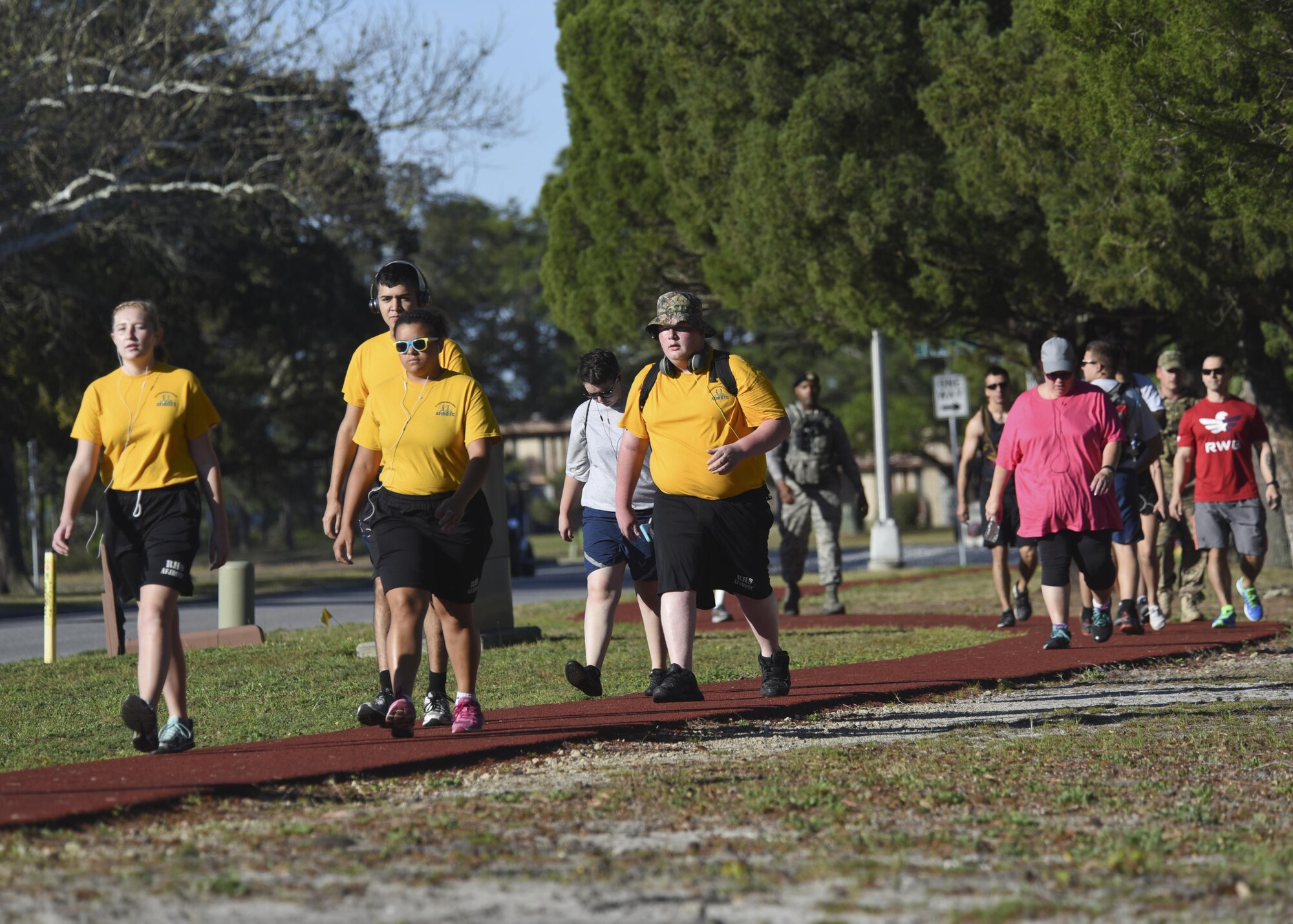 Cadets of the Rutherford High School Junior Reserve Officer Training Corps, their parents and Tyndall Airmen, walk down the Beacon Beach path at Tyndall Air Force Base, Fla., March 31, 2017. After the conclusion of the 14-mile ruck march, the cadets became eligible for the new JROTC Bataan Death March ribbon. (U.S. Air Force photo by Senior Airman Solomon Cook/Released)
