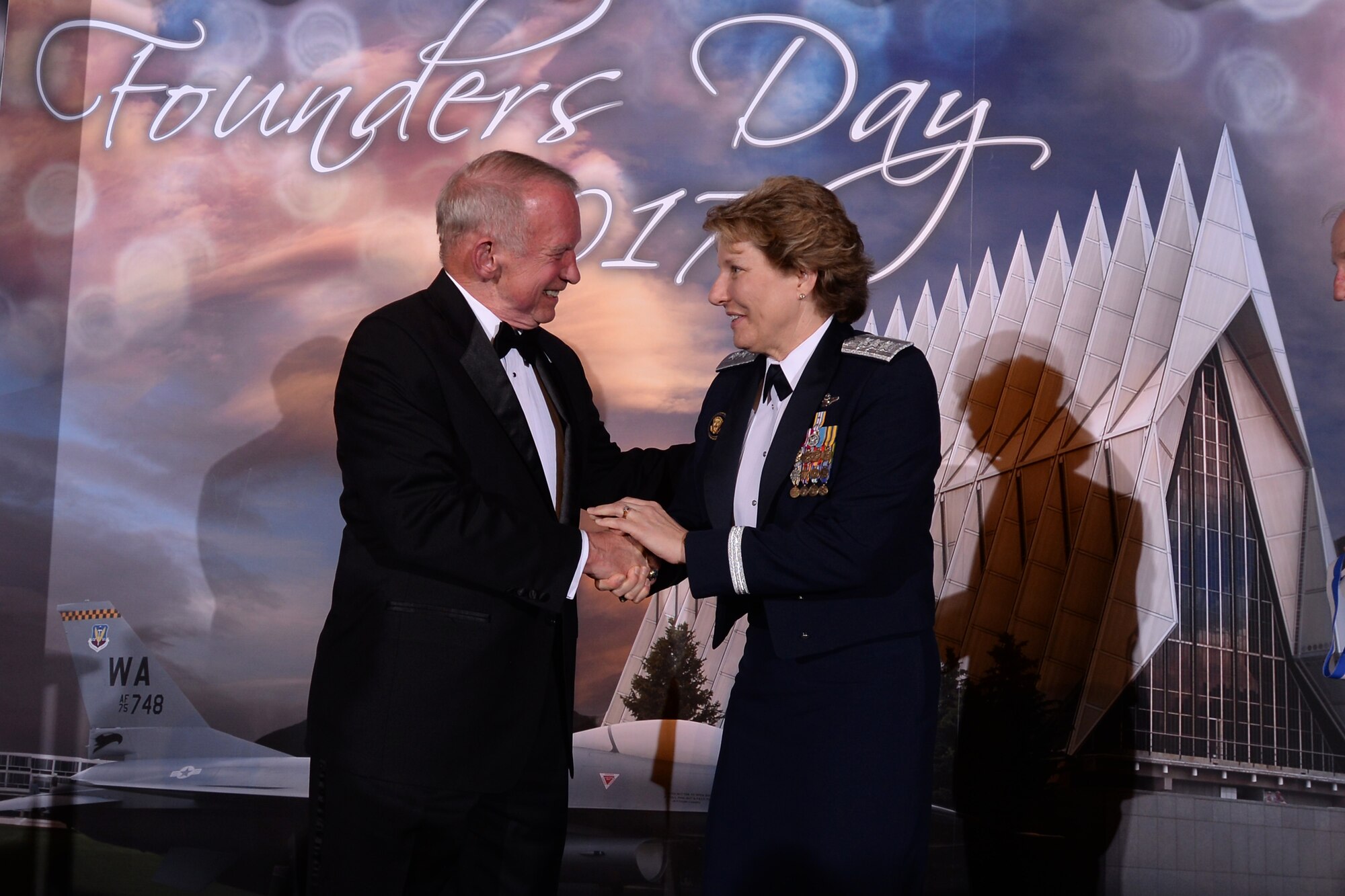 Lt. Gen. Michelle Johnson (left), superintendent of the U.S. Air Force Academy, shakes hands with retired Col. Gary Payton at the Founders' Day Dinner, April 7 at the Falcon Club. Payton, along with retired Gen.s' George Butler and Charles Holland; and David Yost, are the recipients of the 2016 Distinguished Graduate Award. Founders' Day is a traditional celebration of the legacy and future of the Academy and its founders. (U.S. Air Force photo/Mike Kaplan)