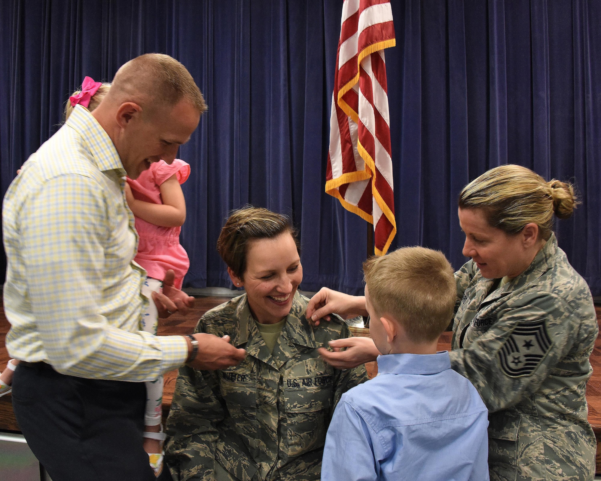 NEW CASTLE AIR NATIONAL GUARD BASE, Del. - Gold bars are pinned onto 2nd Lt. Jenifer Mutter by her husband Army 2nd Lt. Aaron Mutter, 198th Signal Corps, Delaware Army National Guard, her children Alexander and Adalyn, and Chief Master Sergeant Shaune Peters, command chief master sergeant, 166th Airlift Wing, during a commissioning ceremony held on April 11, 2017. (U.S. Air National Guard photo by Tech. Sgt. Gwendolyn Blakley/ Released). 