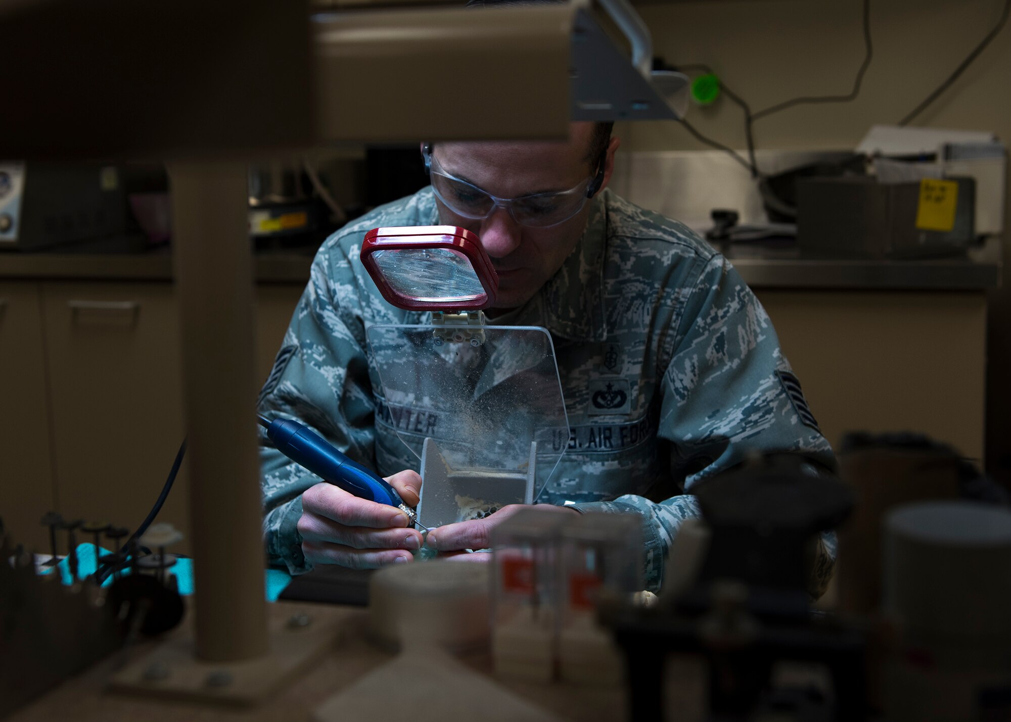 Tech. Sgt. Manuel Painter, 92nd Aerospace Medicine Squadron dental technician, works on dental appliances with precision tools April 07, 2017, at Fairchild Air Force Base, Wash. Magnification is a requirement to precisely shape a crown tooth replacement. (U.S. Air Force photo/A1C Ryan Lackey)