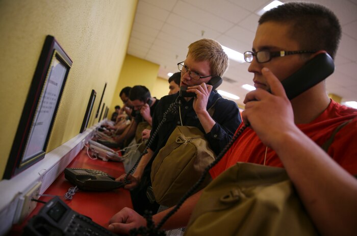 Recruits from Delta Company, 1st Recruit Training Battalion, make their phone calls home, reading only what is printed on the script in front of them, during receiving at Marine Corps Recruit Depot San Diego, April 3. Recruits will not be able to make another phone call until the end of recruit training. Annually, more than 17,000 males recruited from the Western Recruiting Region are trained at MCRD San Diego. Delta Company is scheduled to graduate June 30.