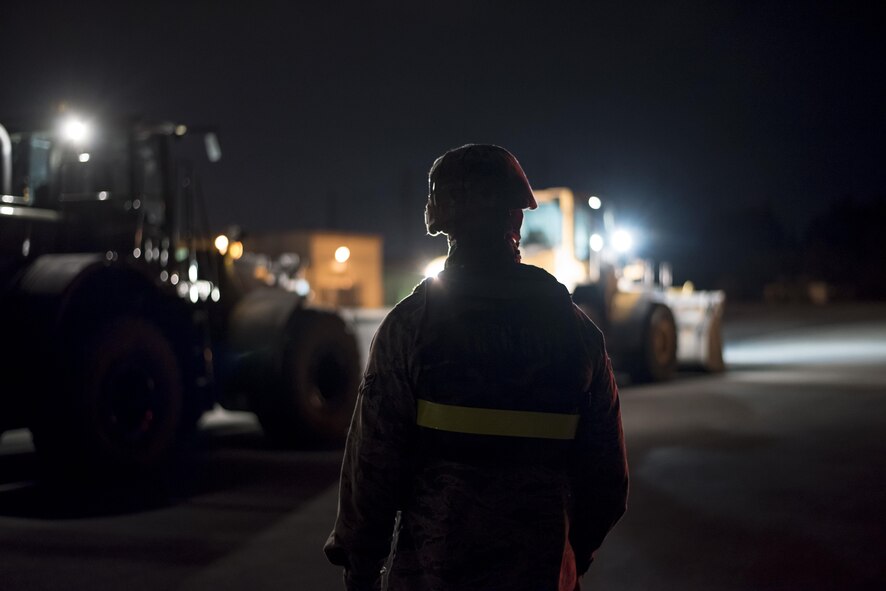 A U.S. Air Force civil engineer Airman from the 18th Civil Engineer Squadron monitors heavy equipment during a no-notice exercise April 12, 2017, at Kadena Air Base, Japan. Airmen from the 18th CES train to ensure they can return Kadena AB’s runways to mission-ready as quickly as possible after an attack or natural disaster. (U.S. Air Force photo by Senior Airman Omari Bernard/Released)