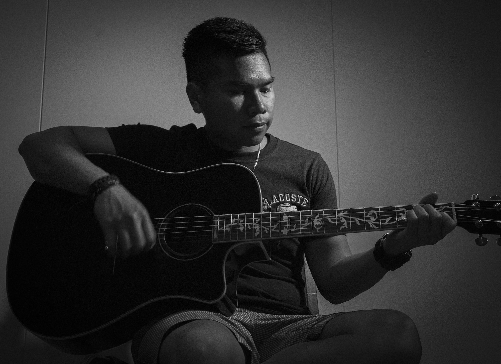 U.S. Air Force Senior Airman Patryk Myko Dela Cruz, a 35th Logistics Readiness Squadron mission generation vehicle equipment maintenance technician, plays a guitar at Misawa City, Japan, April 8, 2017. Dela Cruz played guitar for the base chapel at Minot Air Force Base, North Dakota, which is where he learned of the Leaders Encouraging Airmen Development program. After talking with his leadership, he was able to apply for the program, ultimately getting accepted. (U.S. Air Force photo by Airman 1st Class Sadie Colbert)