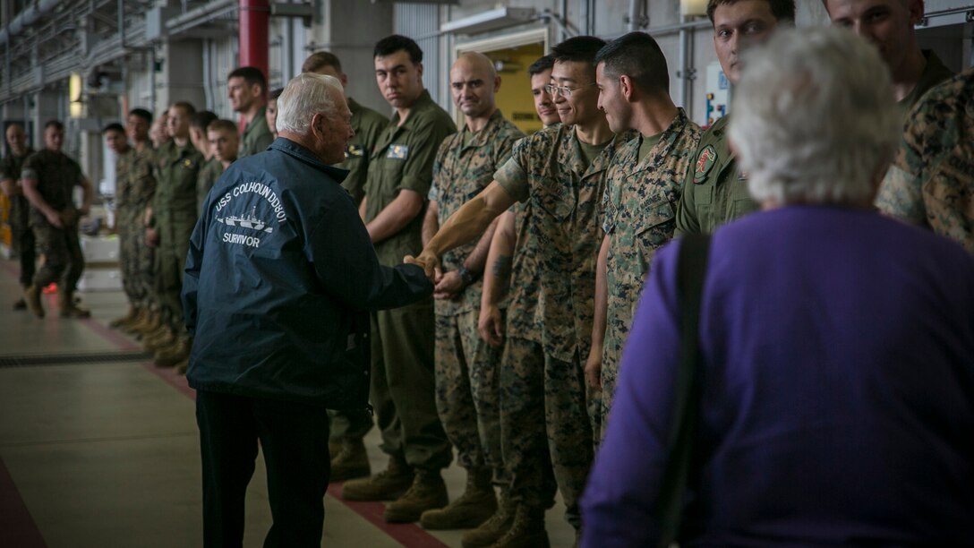 Donald Irwin, a U.S. Navy veteran of World War II, shakes Lance Cpl. Hui Xue’s hand, April 7, 2017, on Marine Corps Air Station Futenma, Okinawa, Japan. Irwin, who served aboard a number of ships during World War II, fought at Midway and Guadalcanal and survived the sinking of the USS Colhoun during the Battle of Okinawa. Irwin returned to Okinawa and exchanged stories with the Marines and Sailors stationed on the island. Irwin is a San Jose, California native, and Xue, a native of New York, is an aviation life support system technician with Marine Medium Tiltrotor Squadron 265, Marine Aircraft Group 36, 1st Marine Aircraft Wing, III Marine Expeditionary Force.