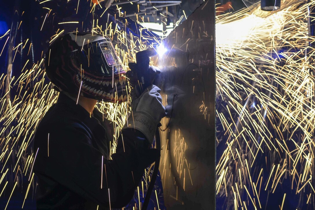 Navy Petty Officer Elias Kinsey cuts a piece of stainless steel aboard the USS Kidd during a composite training unit exercise with the Nimitz Carrier Strike Group in the Pacific Ocean, April 5, 2017. The exercise tested the strike group’s mission readiness. Navy photo by Petty Officer 3rd Class Deanna C. Gonzales