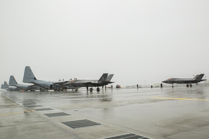 Two U.S. Marine Corps F-35B Lightning II aircraft with Marine Fighter Attack Squadron (VMFA) 121 refuel using a KC-130J Hercules with Marine Aerial Refueler Transport Squadron (VMGR) 152 during aviation delivered ground refueling training at Marine Corps Air Station Iwakuni, Japan, April 11, 2017. The ADGR marked the first evolution of this form of refueling for VMFA-121’s F-35B Lightning II aircraft, and it increases the squadron’s ability to refuel by C-130 aircraft in austere locations when other resources may not be available.  (U.S. Marine Corps photo by Lance Cpl. Joseph Abrego)